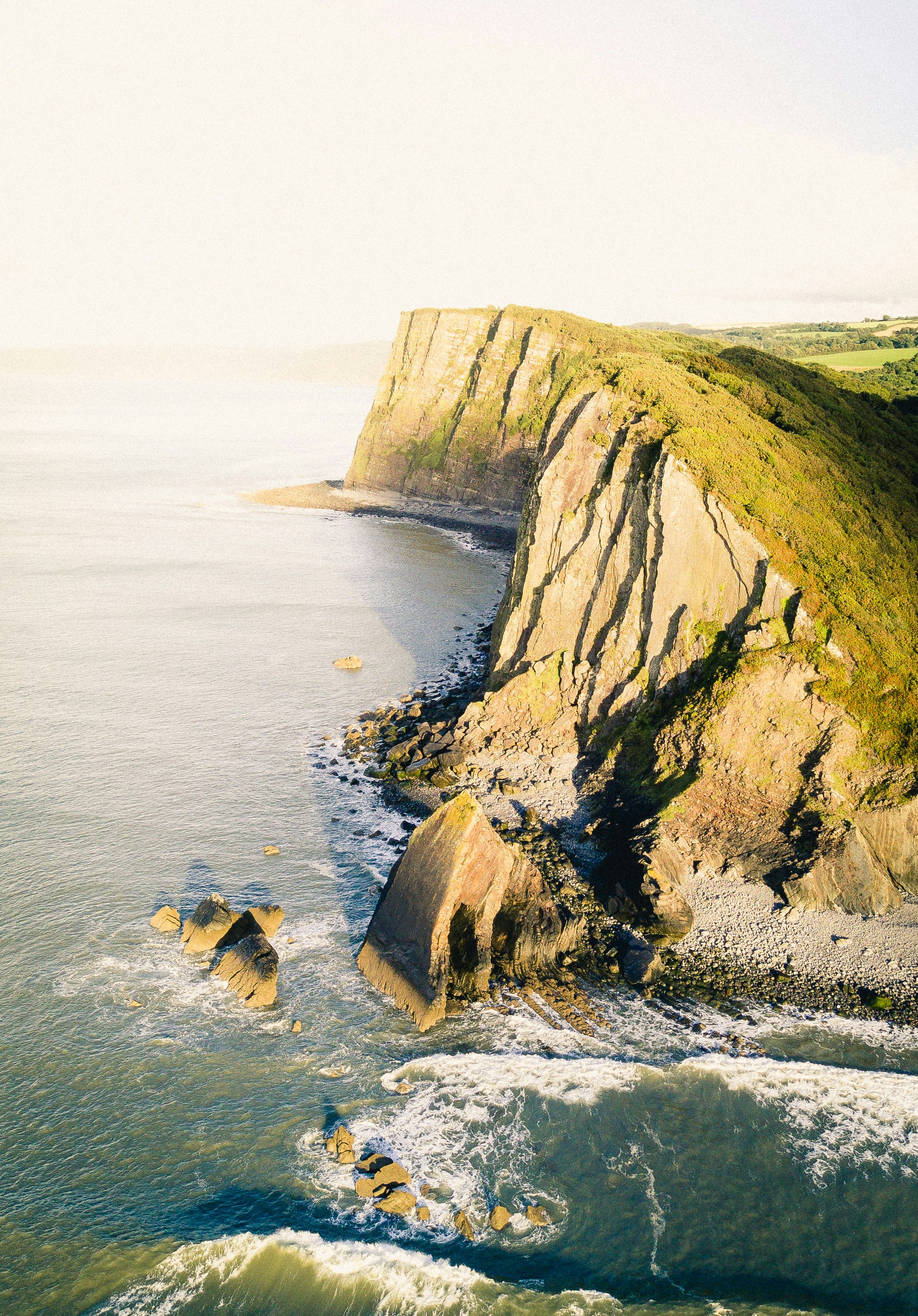 aerial shot of cliff near body of water